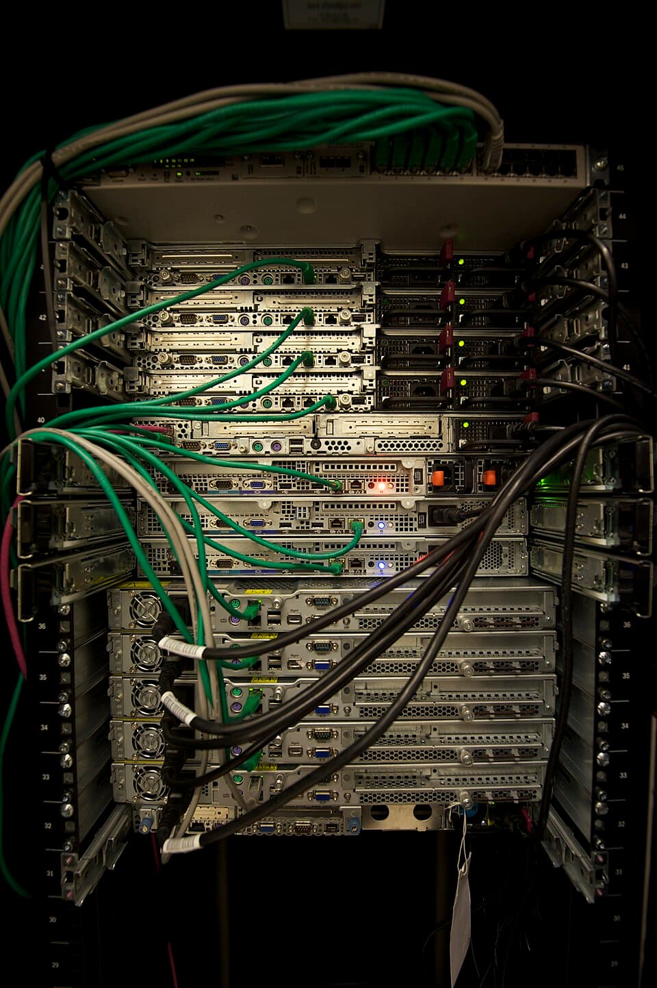 Network and power cabling connected to servers in a rack
